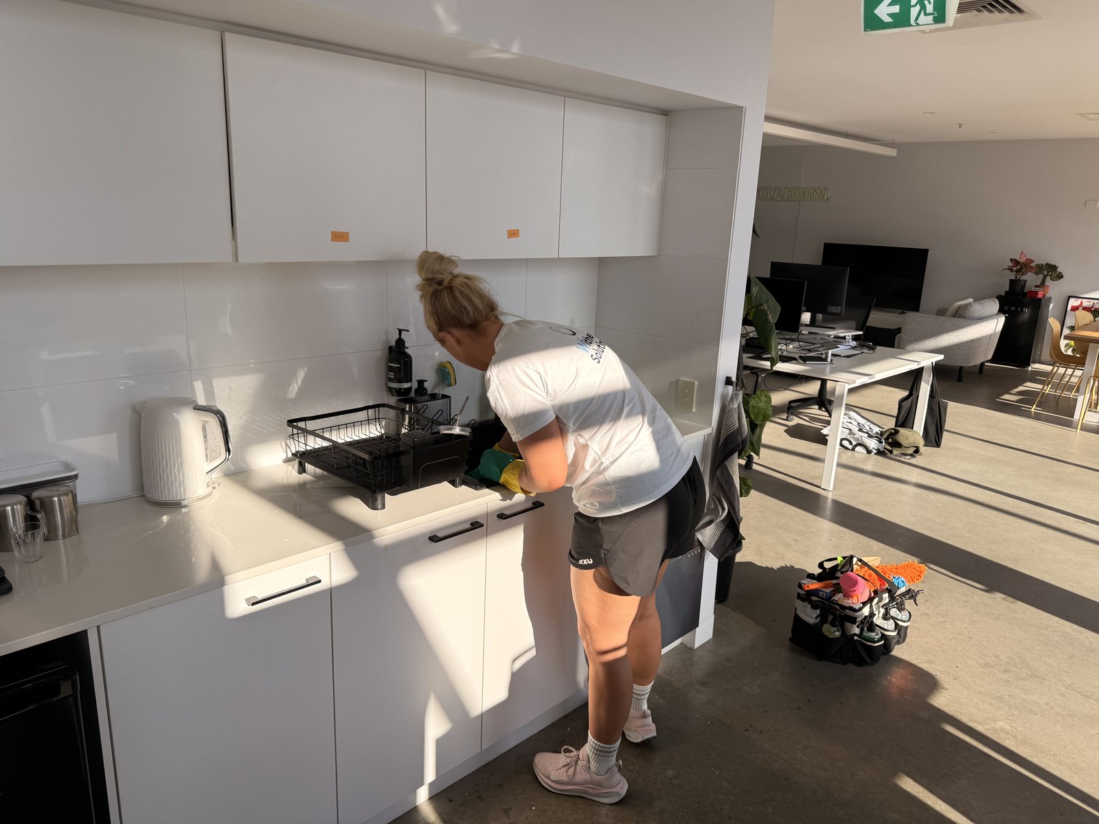 Commercial Cleaning Toorak 2026 Emma wiping the kitchen bench and sink in the Pulp Digital office in Richmond